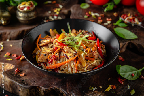 Soba, udon, asian wheat noodles with beef and vegetables: broccoli, carrots, sweet peppers, zucchini