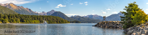 Panoramic view of the harbor with a fishing boat sailing in the distance in Sitka, Alaska.