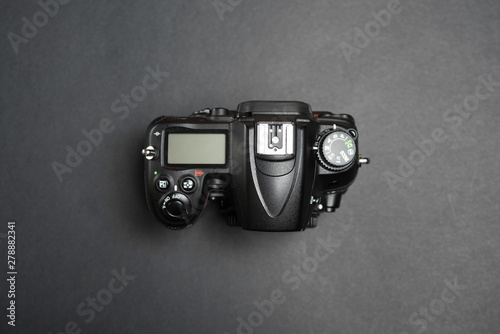 Digital Single Lens Reflex on black background without lens, body view from above on black background