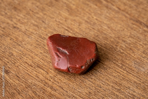 Red Jaspis gemstone gem jewel mineral precious and shiny on wooden underground