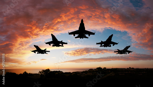 fighter flying in the sky at sunset