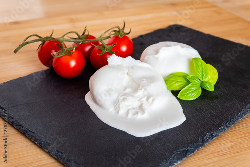 Composition of tomatos, basil and burrata cheese handmade in Puglia, Italy