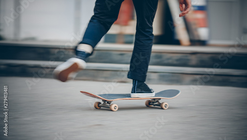 Skateboard man in shoes and jeans getting ready to jump kickflip olli from steps. Blurred background in motion