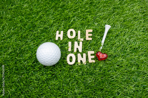 Golf hole in one with love on green grass