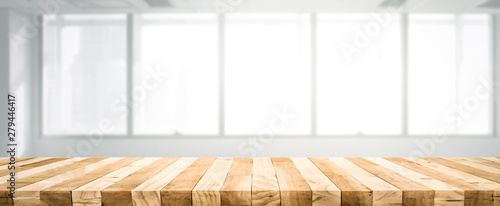 Wood table top bar on blur window glass,wall background(loft style)