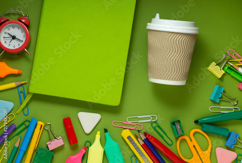 School office supplies on a desk with copy space. Back to school concept. School supplies on green background. Back 2 school concept