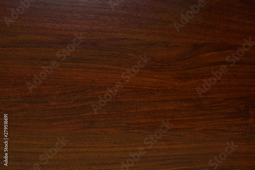 Polished wood texture. The background of polished wood texture with a dark amber color