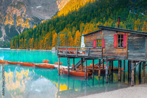 Cute wooden boathouse on the alpine lake, Dolomites, Italy, Europe