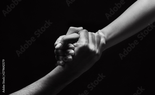 Unrecognizable woman hand helping man to stand up