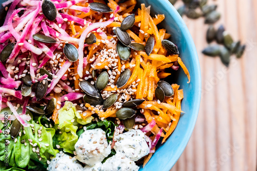 Bol de crudités carottes salade betterave et graines de courge