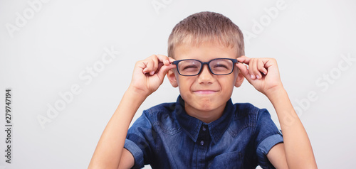 Banner little boy with glasses correcting myopia close-up portrait Ophthalmology problem selective focus