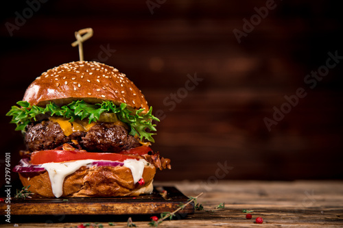 Close-up of home made tasty burger on wooden table.