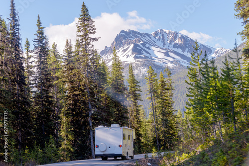 Motorhome Touring the Canadian Rockies on beautiful morning with sunbeam in Banff National Park, Alberta, Canada