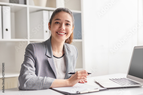 Cheerful office worker with clipboard