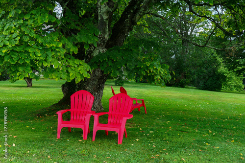 Stockbridge, Massachusetts, USA Red garden chairs on the grounds of the Norman Rockwell Museum.