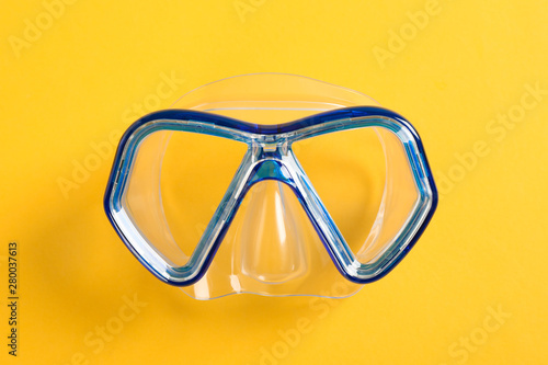 Diving mask on yellow background, space for text