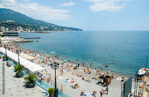 Tourists relax on vacation at the Central beach in Yalta