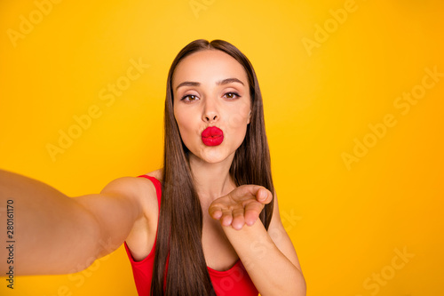 Photo of amazing model lady making selfies hold hand send air kiss blog followers wear red swimming suit isolated yellow background
