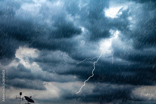 Lightning and thunderstorm flash with raining background. Bad weather and cloudy problem with aerial or satellite signal.