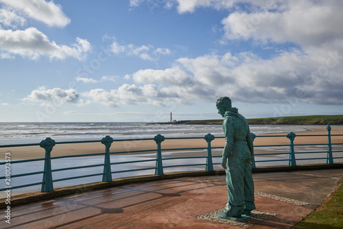 The Minesweeper Sculpture by William Lamb looks across Montrose bay and Scurdie Ness Lighthouse at Montrose in Angus, Scotland.