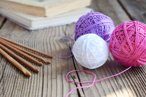 The equipment for knitting and crochet hook, colorful rainbow cotton yarn, ball of threads, wool. Handmade crocheting crafts. DIY concept. Copy space