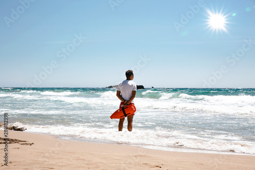 A lifeguard boy on the beach in a summer sunny day