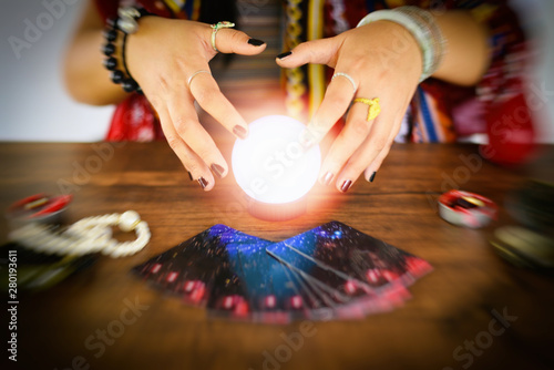 Psychic readings and clairvoyance concept - Crystal ball fortune teller hands and Tarot cards reading divination