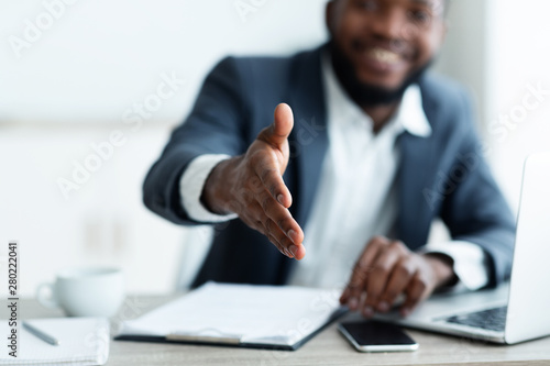 African American businessman extending hand to shake