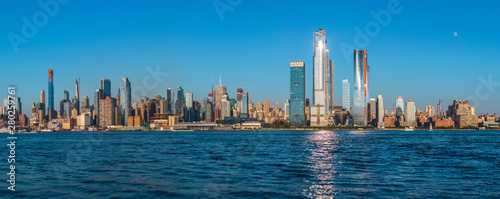 View to Manhattan skyline from Weehawken Waterfront in Hudson River at sunset.