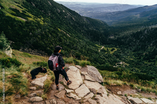 Young woman on the trail in Giant Mountains (Karkonosze), authentic travel experience. 