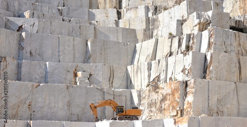 Marble quarry with a Excavator loader, open mining, Italy