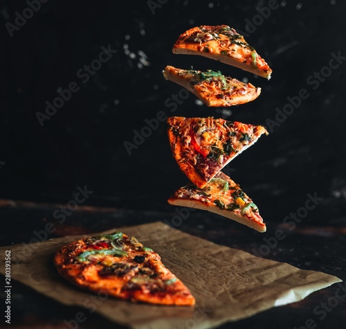 Levitation pizza on black background