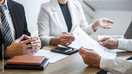 Employer or recruiter holding reading a resume with talking during about his profile of candidate, employer in suit is conducting a job interview, manager resource employment and recruitment concept