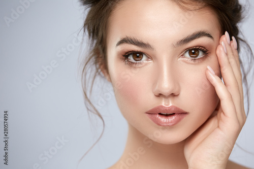close-up portrait of beautiful girl with big eyes and perfect skin looking to camera