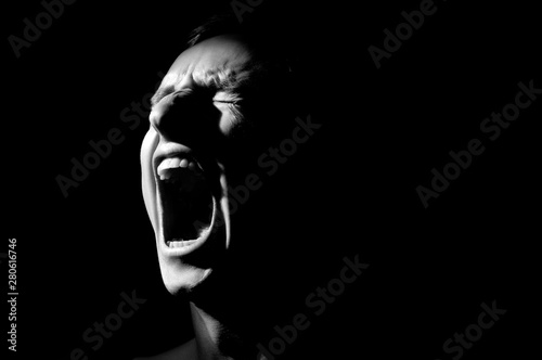 black and white photo on a black background, distorted face screaming