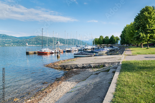 Big Italian lake. Lake Maggiore at Ispra. Small harbor with boats on the lakeside of the tourist town of Ispra, northern Italy