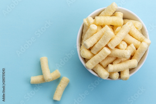 Crunchy corn puffs, pufuleti in white bowl - top view