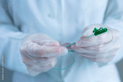 Urological catheter in the hands of a doctor. Close-up.