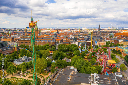 Aerial view of the Tivoli Gardens amusement park with people, visitors, attractions and rides. Urban view of the city of Copenhagen in Denmark, Europe