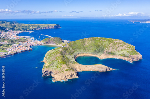 Nature Park of destructed extinct volcano craters of Caldeirinhas, mountain Guia, bay Baia do Porto Pim and port, beaches, marinas, red roofs of historical Horta city, Faial island, Portugal