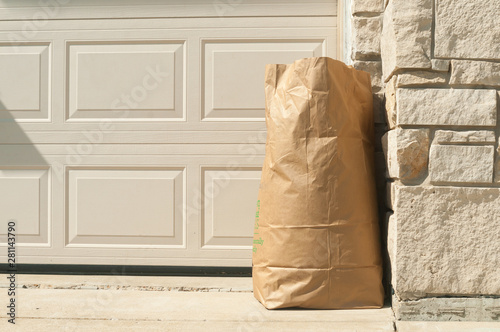 environmental trash bag in front home for concerning about global warming