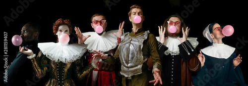 Young people as a medieval grandee on dark studio background. Bubbling up of pink gum. Collage of portraits in retro costume. Human emotions, comparison of eras and facial expressions concept.