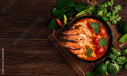 Tom Yum Goong spicy soup traditional food cuisine in Thailand on wooden background , top view, copying area, national food