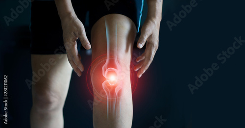 Elderly woman suffering from pain in knee. Tendon problems and Joint inflammation on dark background.