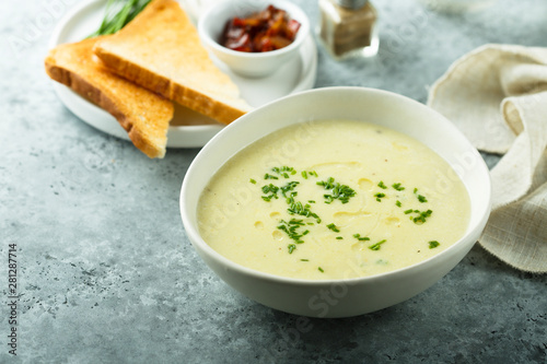 Homemade creamy asparagus soup in a white bowl