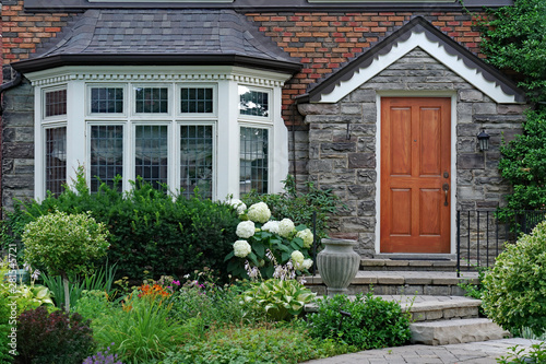 front garden of house with bay window and leaded glass