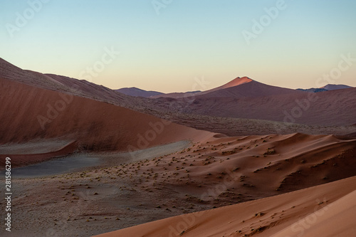 Early morning sunlight illuminating the red sand of Namibias sussusvlei