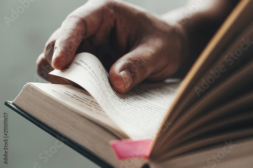 Close up man hands.Young man opening and reading a book,