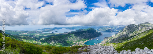 Montenegro, XXL panorama of azure waters of fjord in kotor bay with two cruise ships anchoring in harbor in spectacular nature landscape
