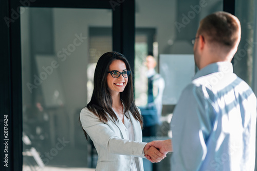 Two business people greeting in the office.